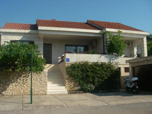 a house with a scooter parked in front of it at Villa Conte in Korčula
