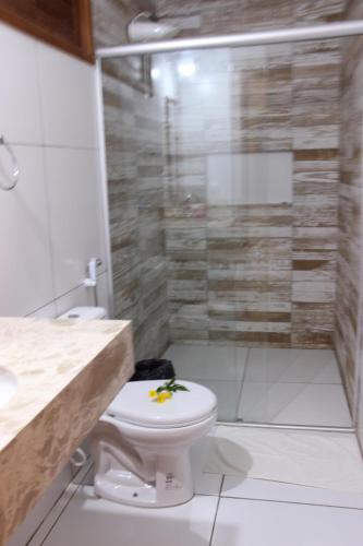a bathroom with a toilet and a shower at Moringa Beach in São Miguel do Gostoso