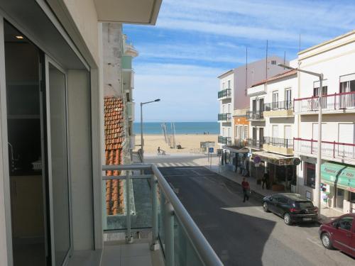 a view of the beach from a balcony of a building at OLY BEACH in Nazaré