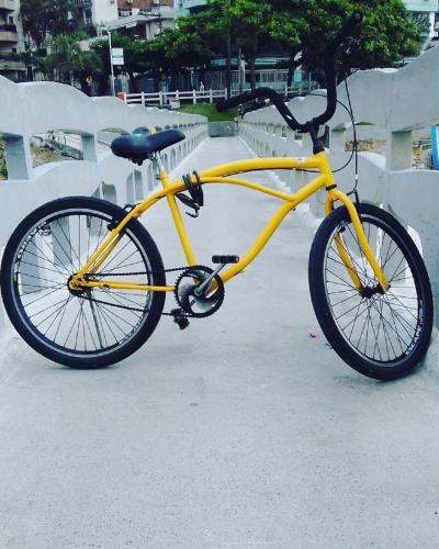 a yellow bike parked next to a wall at Brasileranza Hostel in Niterói