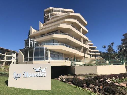 a tall building with a sign in front of it at Sands Beach Breaks Luxury Beach Front Ballito in Ballito