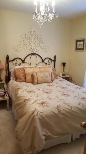 a bedroom with a large bed with a chandelier at Woodstock Inn Bed & Breakfast in Independence