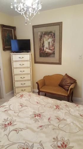 a bedroom with a bed and a dresser at Woodstock Inn Bed & Breakfast in Independence