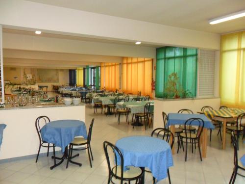 a dining room with tables and chairs with blue tables at Ospitalità San Tommaso d'Aquino in Bologna