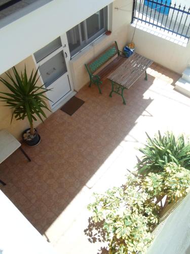 an overhead view of a patio with a bench and plants at Costareli in Fourni Ikarias