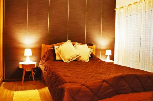 a bedroom with a large bed with two lamps at Martin House - Montenegro - FARO - ALGARVE in Faro