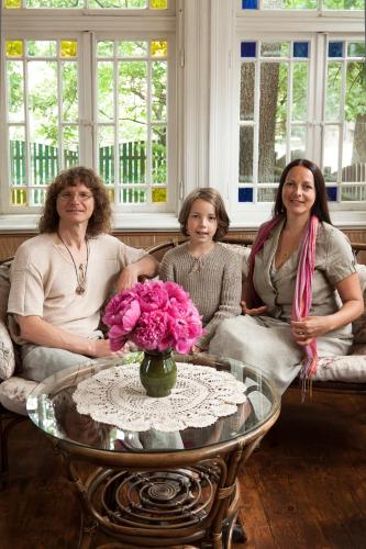 a group of three women sitting in a living room at Ezera Maja in Liepāja