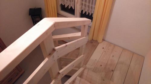 a wooden stairs with a bench in a room at Haus Ruf in Windischgarsten