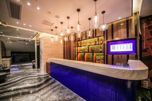 a bar in a restaurant with a blue counter at Chao Man Hotel(Guangzhou Pazhou Exhibition Center Chigang Subway Station) in Guangzhou