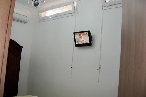a picture hanging on a white wall in a room at Agriturismo Il Pavone in Torre Lapillo