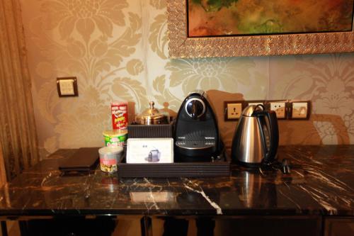a counter with a coffee maker and a telephone on it at Chateau Star River Pudong Shanghai in Shanghai