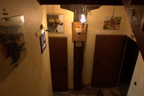 a hallway with two doors and a light in a room at Hostal Rural Elosta in Lekunberri