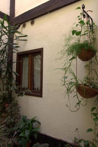 a building with a window with baskets on it at Hostal Rural Elosta in Lekunberri