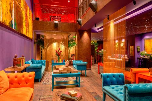 a lobby with blue couches and tables at Prostyle Hotel Ho Chi Minh プロスタイルホテルホーチミン in Ho Chi Minh City