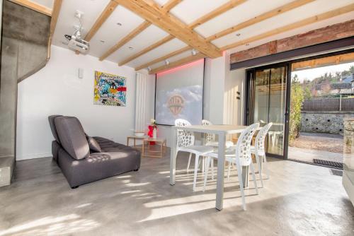 a living room with a white table and chairs at The Tiny House in Honfleur