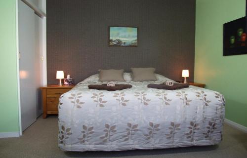 a bedroom with a white bed with two pillows on it at Wellesbourne Homestay B&B in Palmerston North