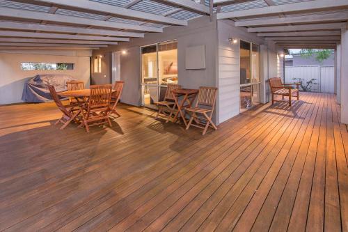 a porch with a table and chairs on a deck at Boardwalk in Quindalup