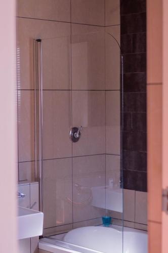 a shower with a glass door in a bathroom at 314 on Clark Guest House in Pretoria