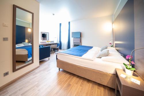Postel nebo postele na pokoji v ubytování Hotel Orangerie