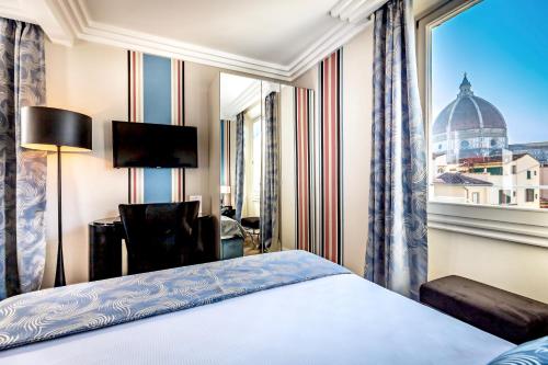 a hotel room with a bed and a window at Arte' Boutique Hotel in Florence