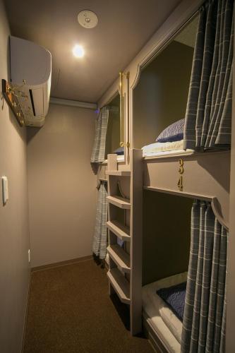 a room with two bunk beds in a trailer at THE WARDROBE Hotel Shimokitazawa in Tokyo