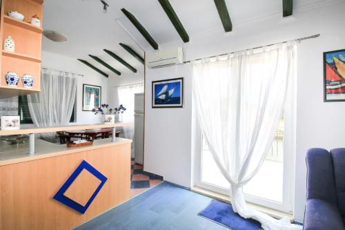 a living room with a large window at Apartment Ida in Trpanj