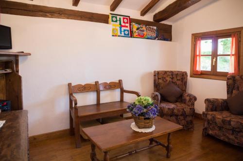a living room with a table and a chair at Casa Katton in Etxalar