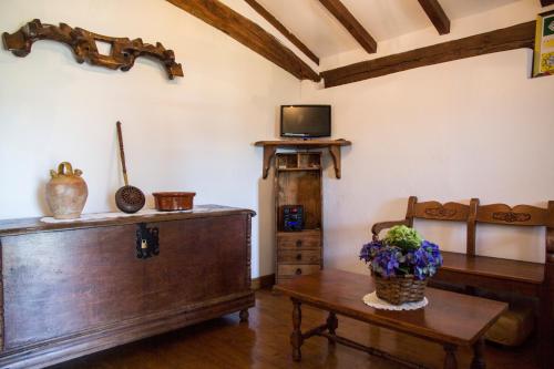 a living room with a table and a tv at Casa Katton in Etxalar