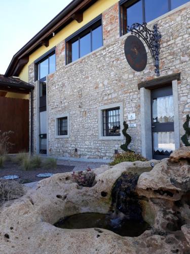 a brick building with a fountain in front of it at Agriturismo San Gallo in Strassoldo