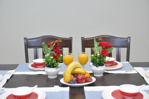 a table with fruit and juice and glasses of orange juice at منازل بلقيس للشقق المخدومة فرع الشفاء in Hail