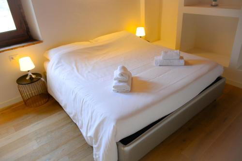 a bedroom with a bed with towels on it at Rocca Palazzaccio in Impruneta