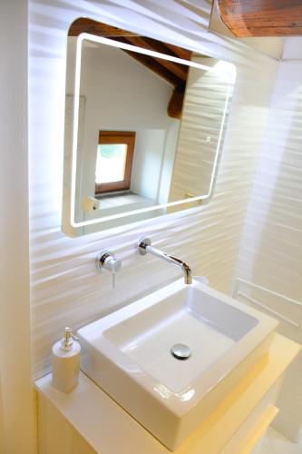 a bathroom with a white sink and a mirror at Rocca Palazzaccio in Impruneta