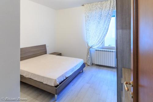 a bedroom with a bed and a window at appartamento ristrutturato a nuovo !!! in Varazze