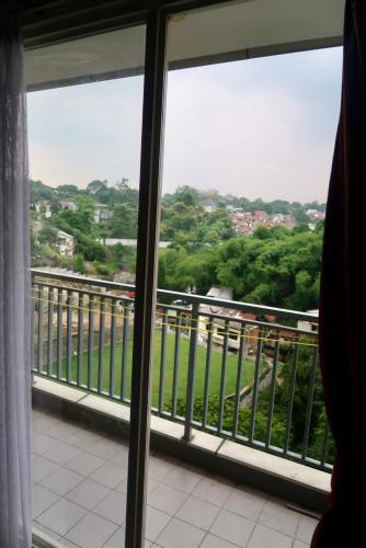 a view from a window of a balcony at Bacup Studio Apartment @Galeri Ciumbuleuit in Bandung