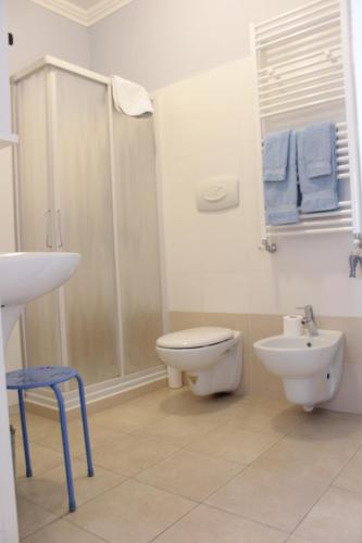 a bathroom with a toilet and a shower and a sink at Perfect apartment Como in Como