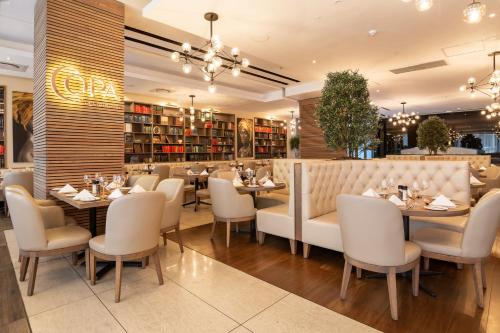 a dining room with tables and chairs in a restaurant at Pepperclub Hotel in Cape Town
