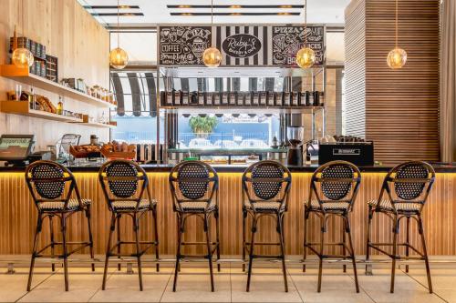 a group of chairs sitting in front of a bar at Pepperclub Hotel in Cape Town
