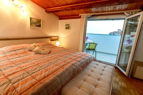 1 dormitorio con cama y ventana grande en Apartments Pyros, en Piran
