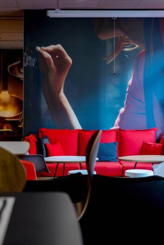 a wall with a picture of a woman smoking at ibis Toulouse Centre in Toulouse