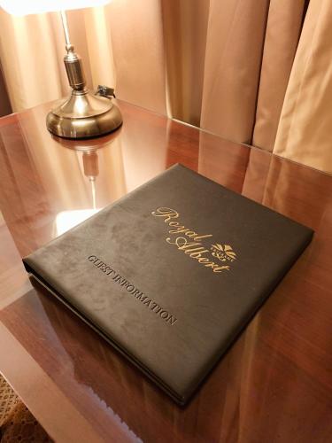 a book sitting on top of a wooden table at Royal Albert Hotel in Brisbane