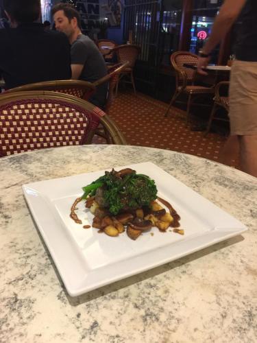 a white plate of food on a table at Royal Albert Hotel in Brisbane