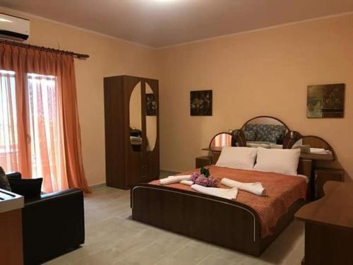a bedroom with a large bed and a mirror at Studios Anna Paradise in Skala Potamias