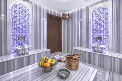 a painting of a kitchen with fruit in a room at Alachi Hotel in Alaçatı
