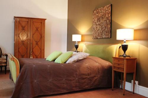 a bedroom with a bed with two lamps on it at Résidence et Chambres d'Hôtes de La Porte d'Arras in Douai