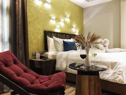 a bedroom with a bed and a table and a chair at Aspira D'Andora Sukhumvit 16 - Asoke in Bangkok