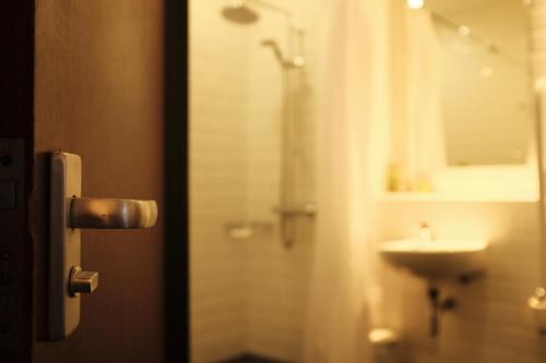 a bathroom with a shower and a sink at Best Western Garfield House Hotel in Chryston