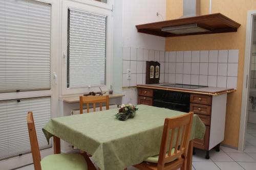 a kitchen with a table with a green table cloth at Weinkeller Wölk in Naumburg