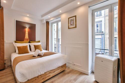 une chambre avec un grand lit et une fenêtre dans l'établissement 65-FRENCH CANCAN ST DENIS, à Paris