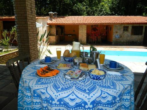 a blue and white table with food and drinks on it at Solar das Canoas Prumirim in Ubatuba