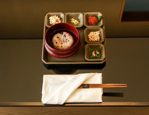 a plate of food with a bowl of food and chopsticks at MOGANA in Kyoto